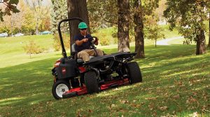 man driving mower in park